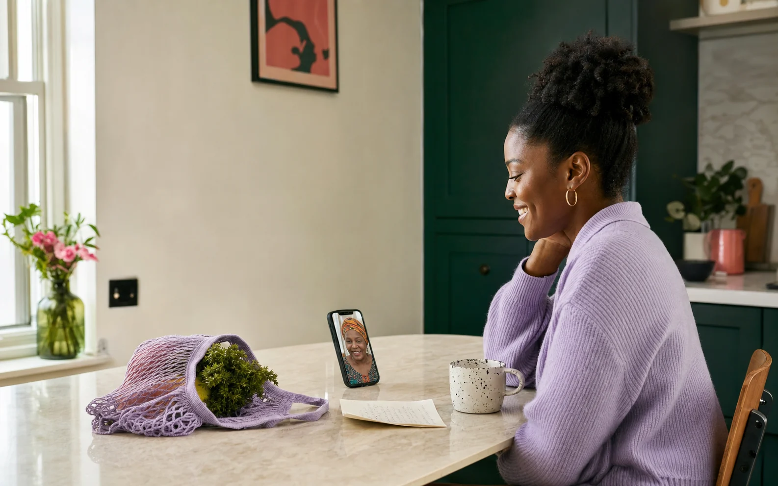 A woman talking with a family member on a video call at her kitchen table